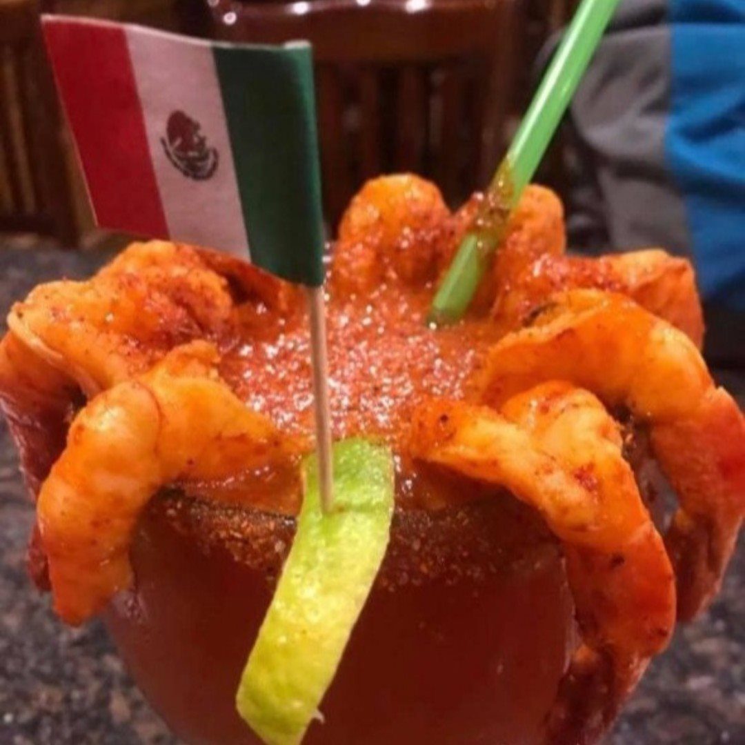 Shrimp botanera served in a chilled glass with a Mexican flag
