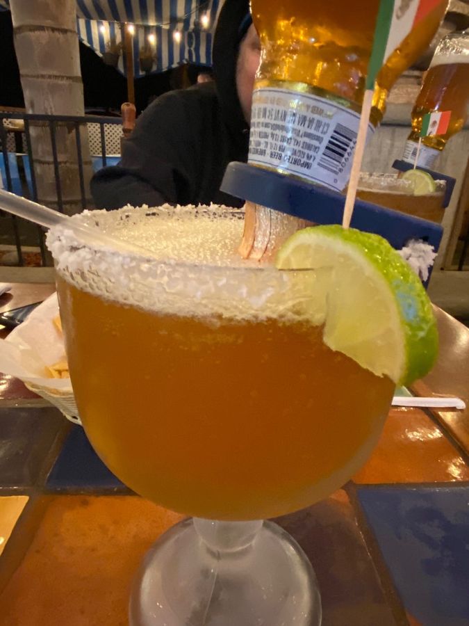 A michelada with a chile salt rim and lime
